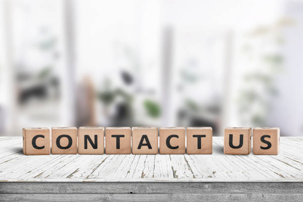 Contact us sign on a wooden desk stock photo