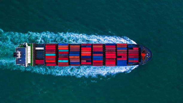 container freight ship carrying container box for import and export business logistic and transportation by container ship in open sea, aerial view. - aerial container ship imagens e fotografias de stock