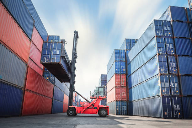 Container Ship Loading of Import/Export Freight Transportation Industry, Transport Crane Forklift is Lifting Box Containers at Port Cargo Shipping Dock Yard. Logistic Freighting Ship Service stock photo