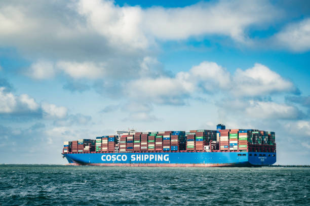 Container ship of COSCO SHIPPING leaving the port of Rotterdam stock photo