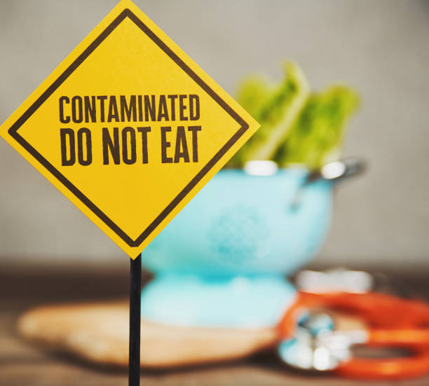 Contaminated Lettuce with Warning Sign  contamination stock pictures, royalty-free photos & images