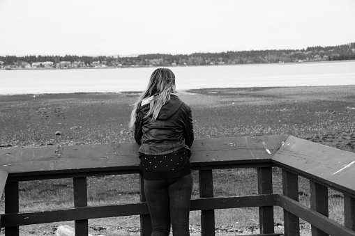Contemplative Woman On The Dock Stock Photo - Download Image Now - iStock