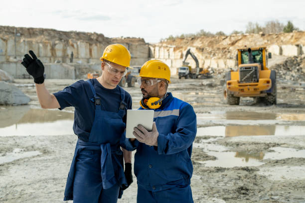 Contemporary builders discussing sketch in tablet stock photo