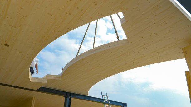 CLOSE UP: Contemporary CLT house is being assembled on a sunny spring day. stock photo