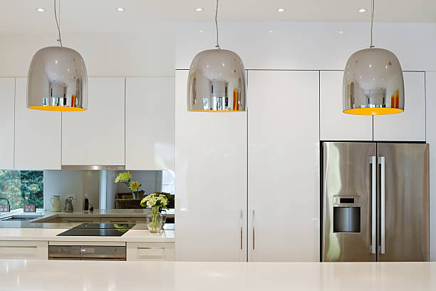 Contemporary pendant lights hanging over kitchen island stock photo
