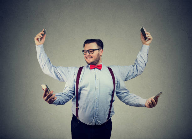 Content businessman with plenty of gadgets Chunky young man in formal clothing having four arms and using smartphones being multitasking. fat man looks at the phone stock pictures, royalty-free photos & images