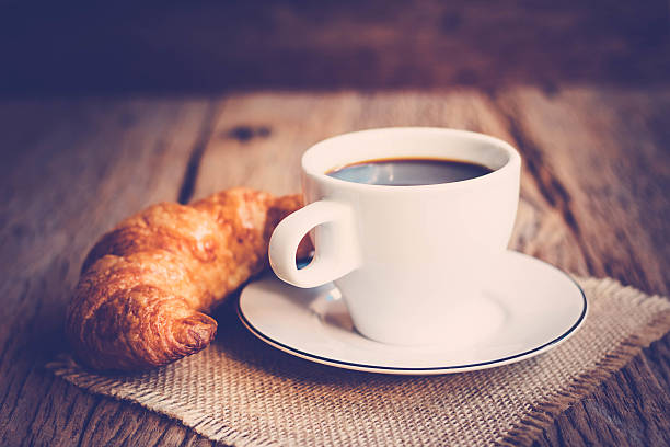 Continental breakfast with coffee and croissant stock photo