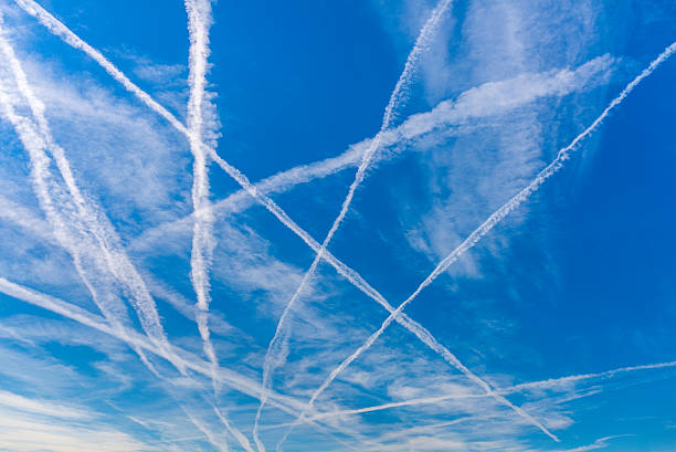 Contrails Contrails over blue sky. vapor trail stock pictures, royalty-free photos & images