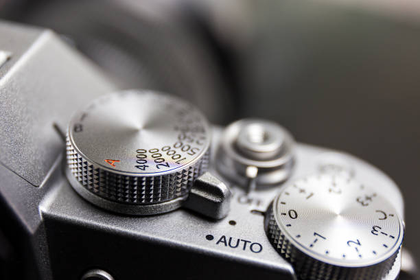 control dial of exposure, button, on silver mirrorless camera stock photo