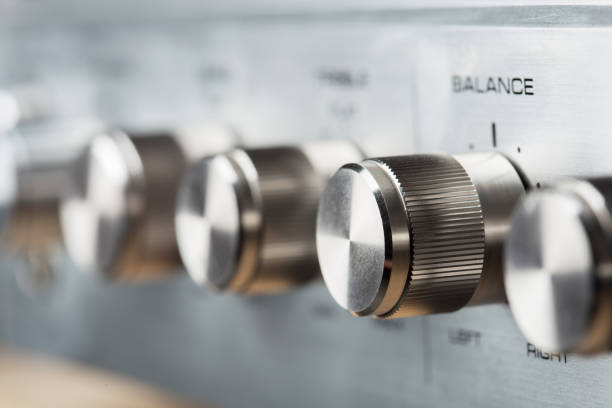 Control Knobs on a Silver Metallic vintage Amplifier - Shallow Depth of Field stock photo