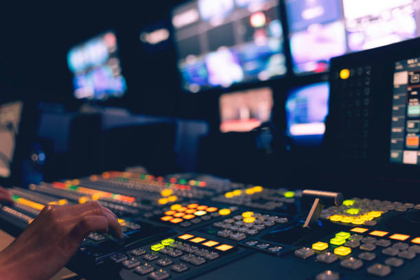 Controlled in a broadcast studio. Video mixer use stock photo