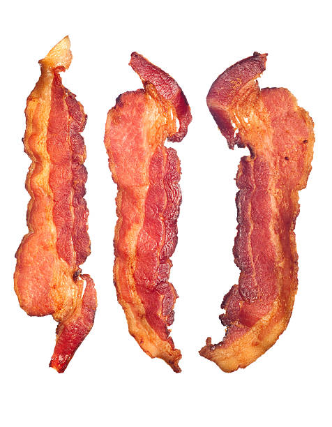 Cooked bacon strips "Three cooked, crispy fried bacon isolated on a white background.  Good for many health and cooking inferences." bacon stock pictures, royalty-free photos & images