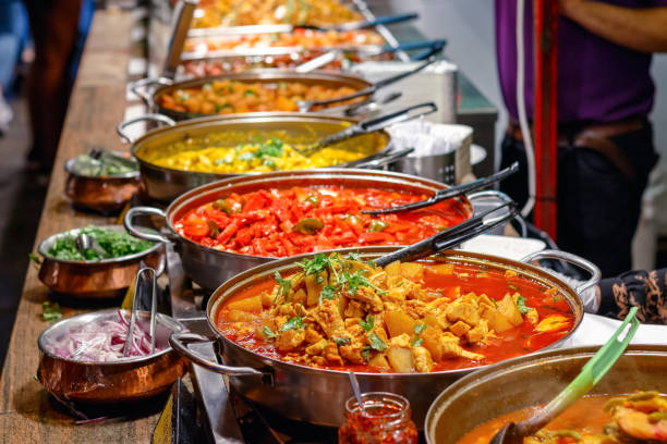 Cooked curries on display at Camden Market in London Variety of cooked curries on display at Camden Market in London curry meal stock pictures, royalty-free photos & images