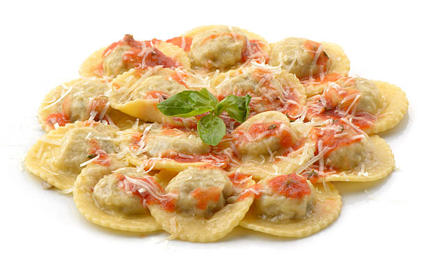 cooked ravioli with tomato sauce and cheese stock photo