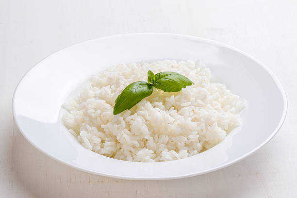 cooked rice with basil stock photo