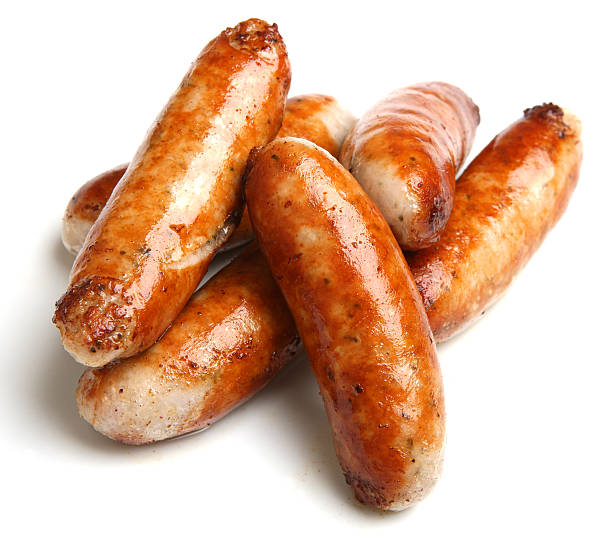 Cooked sausage piled together with a white background Stack of cooked sausages. sausage stock pictures, royalty-free photos & images