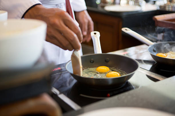 Cooking a fried egg stock photo