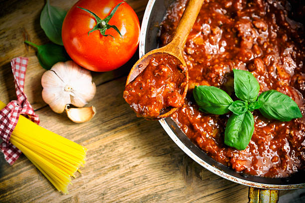 Cooking Bolognese Sauce Spaghetti Bolognaise Sauce  in the Pot on the wooden table bolognese sauce stock pictures, royalty-free photos & images