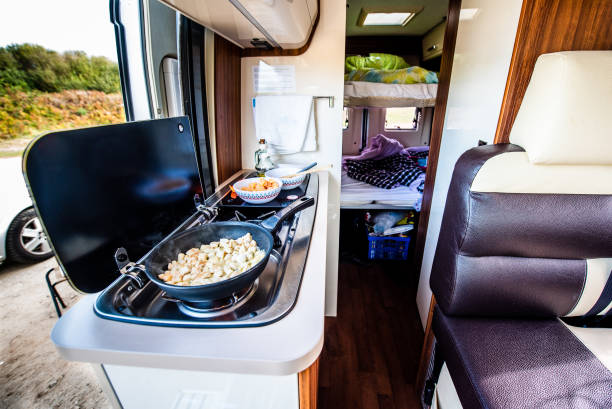 Cooking dinner or lunch in campervan, motorhome or RV. stock photo