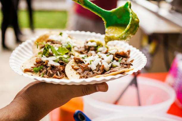 cooking Mexican tacos with beef, traditional street food in Mexico city stock photo
