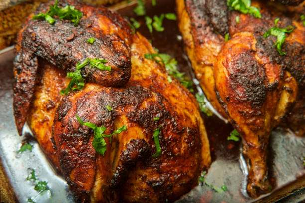 Cooking Peruvian Halved Chicken stock photo