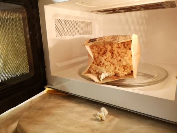 cooking popcorn in the microwave cooking popcorn in the microwave microwave stock pictures, royalty-free photos & images