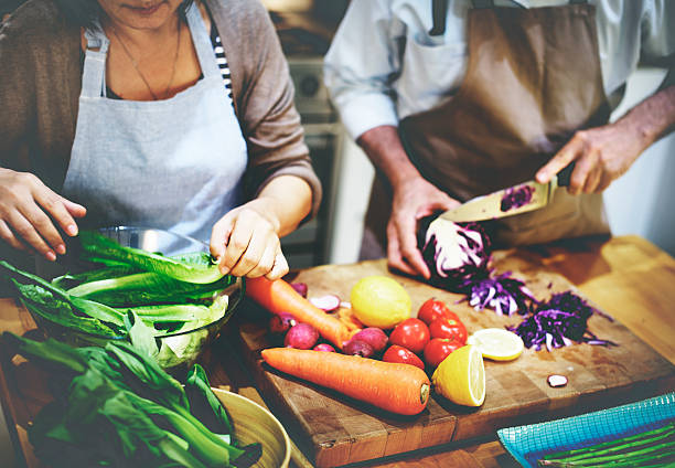 preparação de ingredientes para cozinhar comida vegetariana conceito - woman chopping vegetables imagens e fotografias de stock