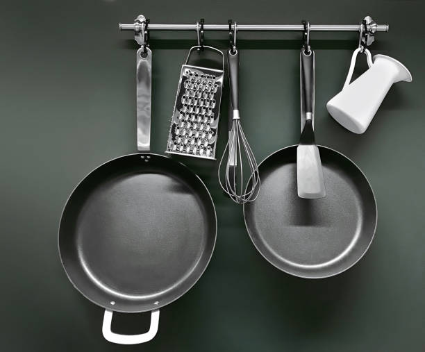Cooking utensils Cooking utensils hanging on a pot rack grater utensil stock pictures, royalty-free photos & images