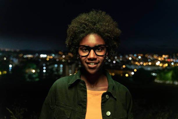 Cool young woman with city views at twilight stock photo