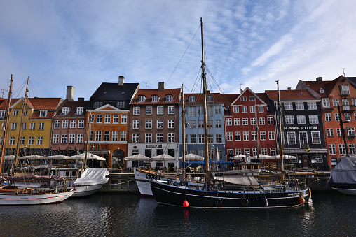 Copenhagen Nyhavn old harbour canal street view, Denmark. It's very famous and old historical district so lots of tourists visit this area every year. Good bars, restaurants and shops are located here.