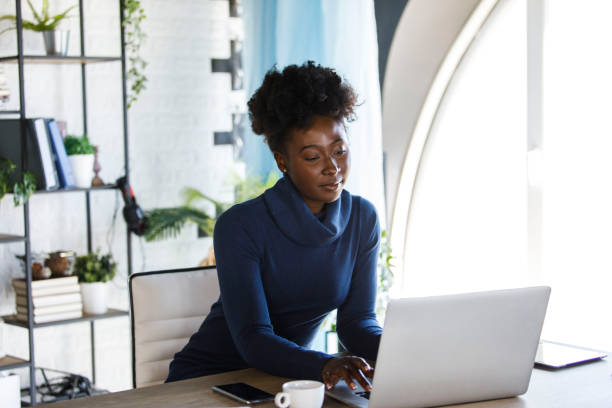 Copy space shot of businesswoman logging in on her laptop in the morning stock photo