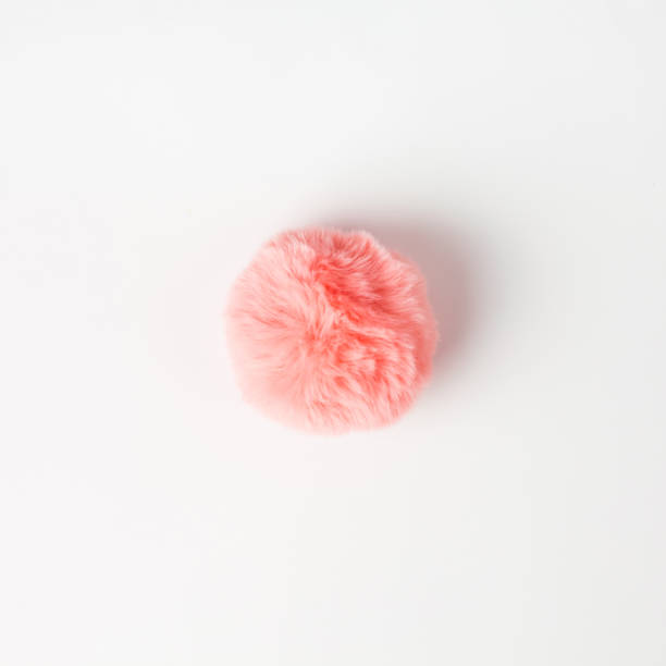 Coral fluffy fur ball on white background stock photo