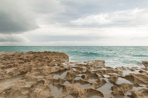 Coral Rock Shoreline in Singer Island Beach in South Florida at Sunset.