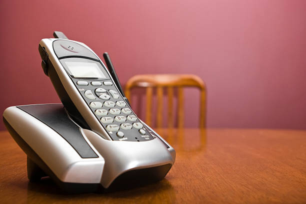 Cordless phone on a table with chair stock photo