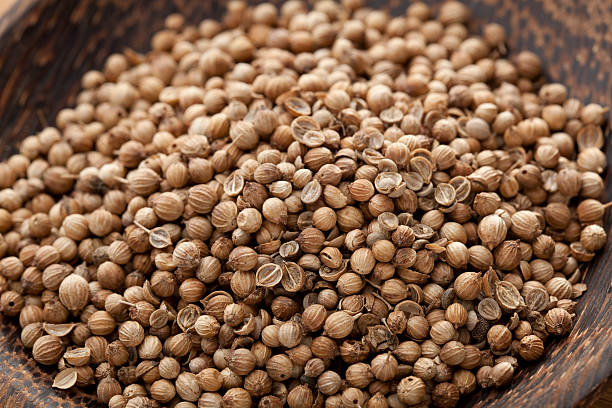 Coriander Seed Coriander Seed in wooden bowl coriander seed stock pictures, royalty-free photos & images