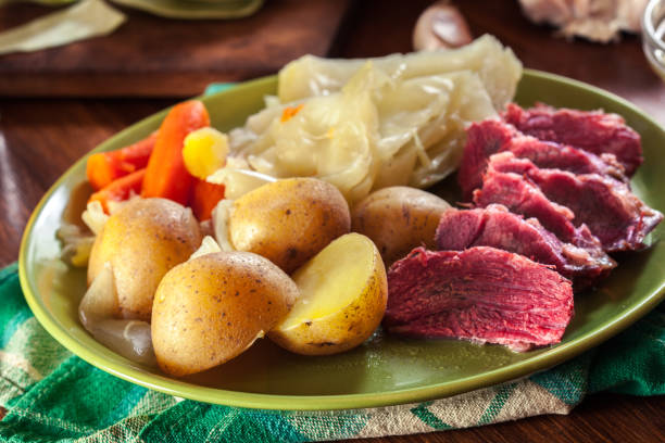 Corned beef and cabbage with potatoes and carrots Corned beef and cabbage with potatoes and carrots on St Patrick's Day cabbage stock pictures, royalty-free photos & images
