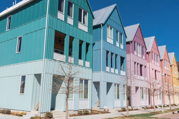 Corner of colorful new development three-story townhome style houses with metal roofs and enclosed balcony under sunny clear blue sky in Wheeler District, Oklahoma City, USA stock photo