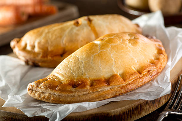 Cornish Pasty Delicious homemade Cornish pasties with beef, carrot, and potato. baked pastry item photos stock pictures, royalty-free photos & images