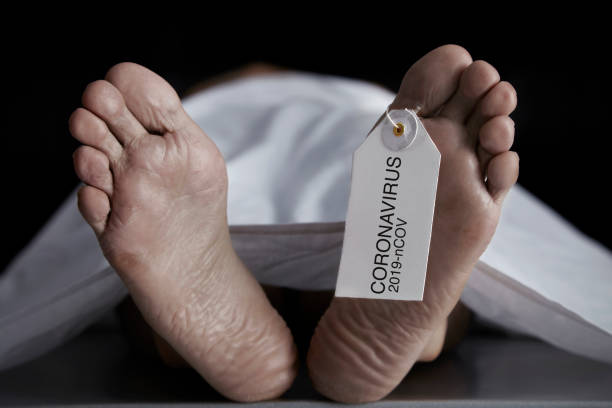 Coronavirus Death Adult male died from coronavirus and lies at the morgue. dead people stock pictures, royalty-free photos & images