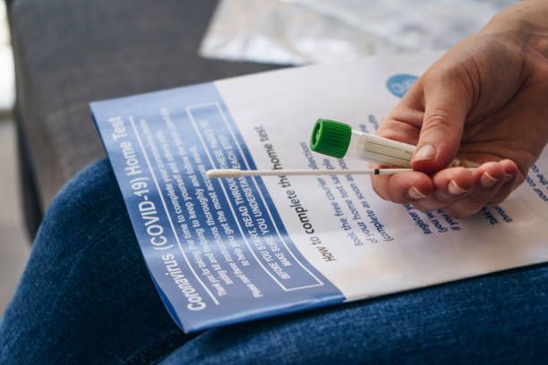 Coronavirus Home Test (COVID-19) Young woman  holds a swab and medical tube for the coronavirus / covid19 home test medical exams stock pictures, royalty-free photos & images