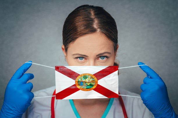 Coronavirus in U.S. State Florida, Female Doctor Portrait, protect Face surgical medical mask with Florida Flag. Illness, Virus Covid-19 in Florida Coronavirus in U.S. State Florida, Female Doctor Portrait, protect Face surgical medical mask with Florida Flag. Illness, Virus Covid-19 in Florida florida us state photos stock pictures, royalty-free photos & images