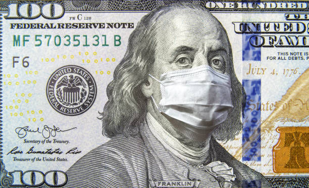 COVID-19 coronavirus in USA, 100 dollar money bill with face mask. Coronavirus affects global stock market. COVID-19 coronavirus in USA, 100 dollar money bill with face mask. Coronavirus affects global stock market. World economy hit by corona virus outbreak and pandemic fears. Crisis and finance concept. american one hundred dollar bill stock pictures, royalty-free photos & images