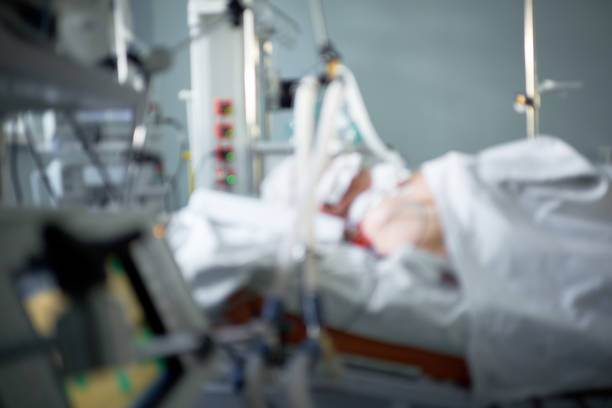 Coronavirus pandemic. Blurred image of intensive care emergency room with hemodialysis machine, ventilator. Patient with coronavirus in critical stance. stock photo