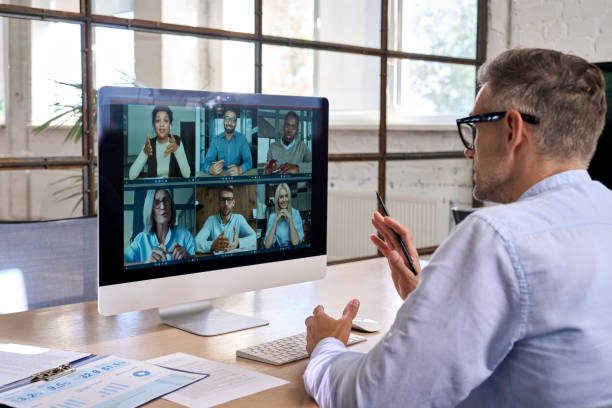 Corporate manager leading videoconference with team business people on computer. stock photo