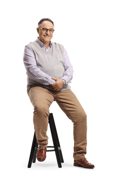 Corpulent mature man sitting on a high chair stock photo