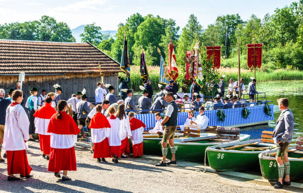 corpus christi procession Seehausen, Germany - May 31: a special bavarian corpus christi procession in Seehausen, germany, where the faithful use boats for part of the route on may 31, 2018 lake staffelsee stock pictures, royalty-free photos & images