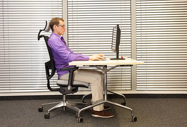 correct-sitting-position-at-workstation-with-computer-picture-id598056392