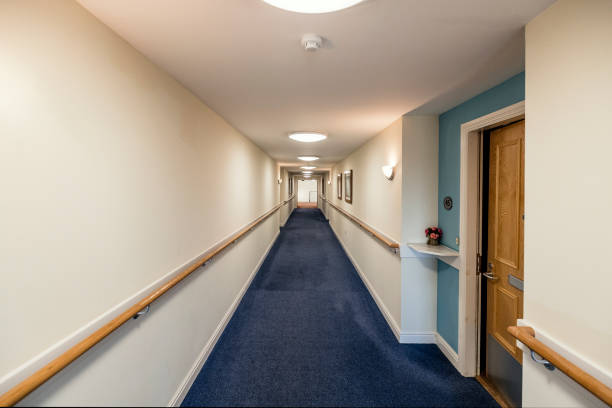 Corridor of a Care home Empty corridor of a care home for the elderly based in England. bannister stock pictures, royalty-free photos & images