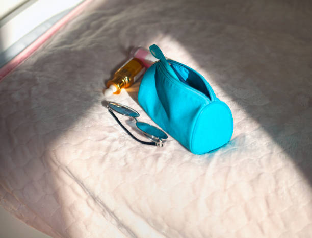 cosmetic bag and sunglasses stock photo