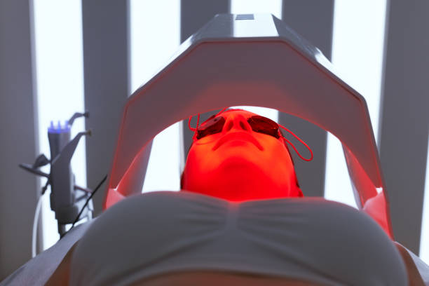Cosmetology. Woman Face At Red Light Treatment At Beauty Clinic Cosmetology. Woman Face Getting Red Light Oxygen Treatment At Beauty Clinic. Facial Photo Therapy. High Resolution infrared stock pictures, royalty-free photos & images